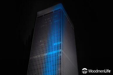 WoodmenLife Tower lit in black with a blue stripe