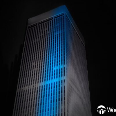 WoodmenLife Tower lit in black with a blue stripe