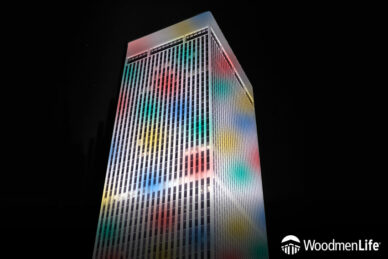 WoodmenLife Tower lit with confetti