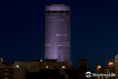 WoodmenLife Tower lit in purple