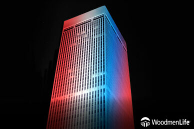 WoodmenLife Tower lit in red, white and blue