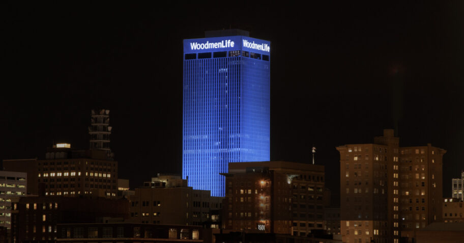 WoodmenLife Tower lit in blue