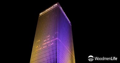 WoodmenLife Tower lit in orange and purple