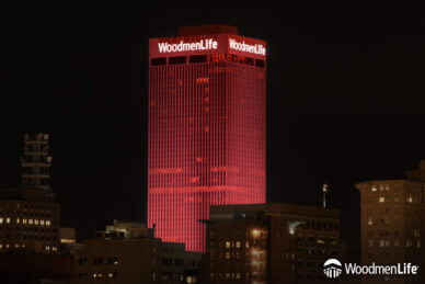 WoodmenLife Tower lit in red