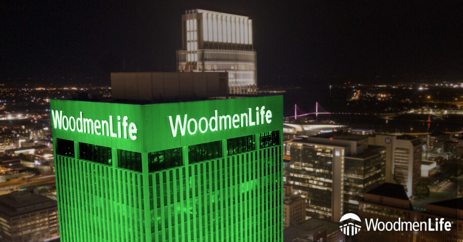 WoodmenLife Tower lit in green