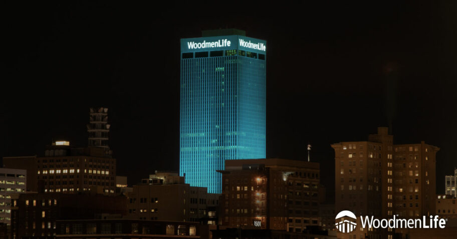 WoodmenLife Tower lit in teal
