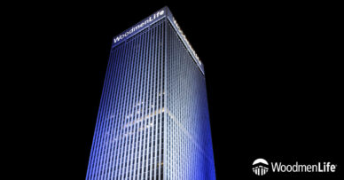 WoodmenLife Tower lit in blue and white