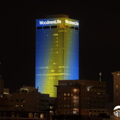 WoodmenLife Tower lit in blue and yellow