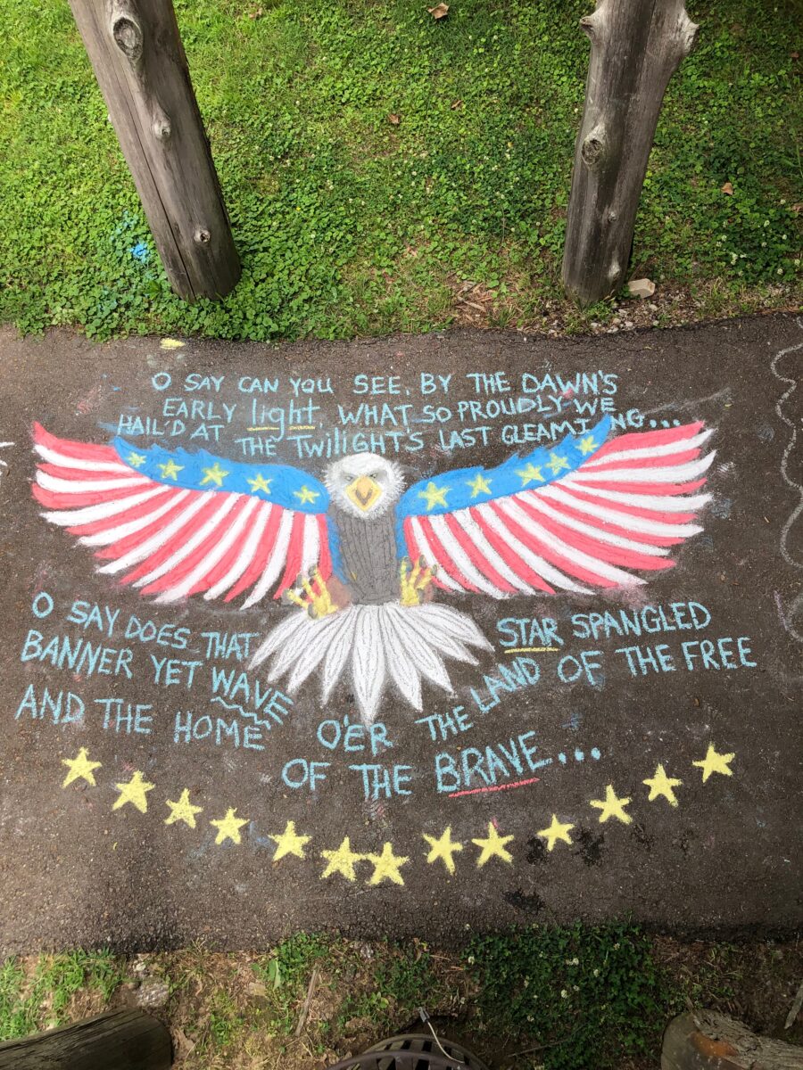 A chalk illustration of an eagle and the star spangled banner lyrics